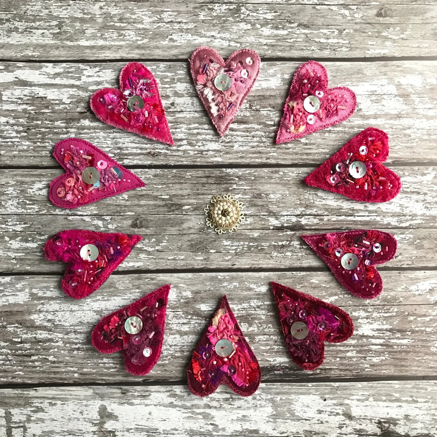 Fabric heart brooches in pinks